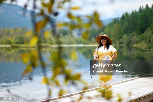 first nations woman performing a welcome song - canadian culture stock pictures, royalty-free photos & images