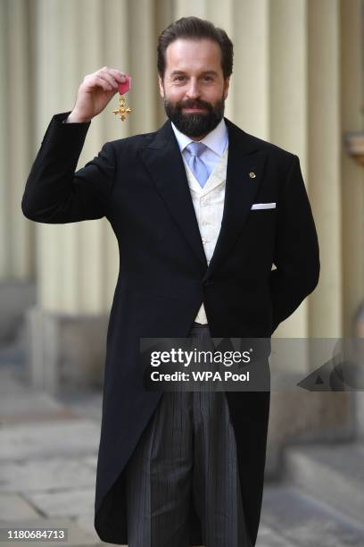 Alfie Boe poses with his OBE medal presented by the Prince of Wales during an investiture ceremony at Buckingham Palace, on November 7, 2019 in...