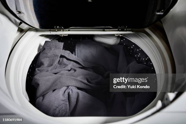 clothing in the washing machine. - wäsche stock-fotos und bilder