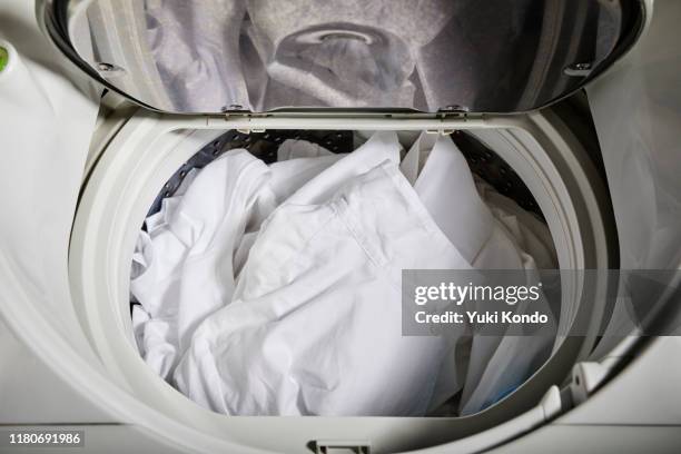 clothing in the washing machine. - white laundry foto e immagini stock