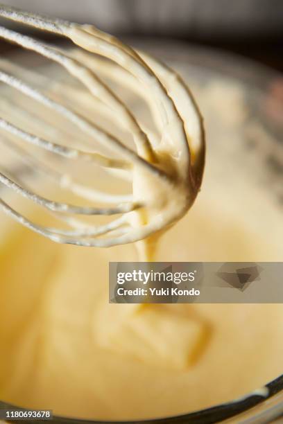 mix the cake dough in the bowl with a whisk. - kuchenteig stock-fotos und bilder