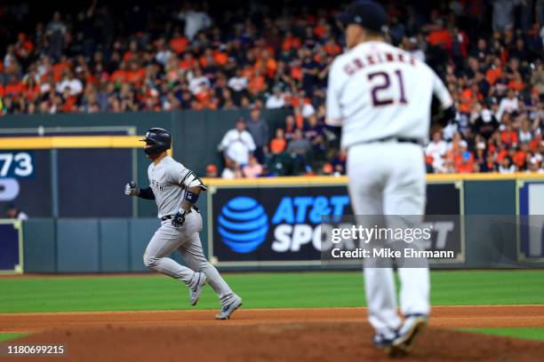 Zack Greinke of the Houston Astros reacts as Gleyber Torres of the New York Yankees rounds the bases following his solo home run during the sixth...
