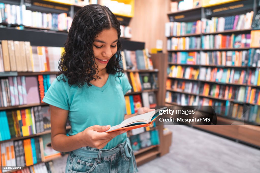 Student reading book in library