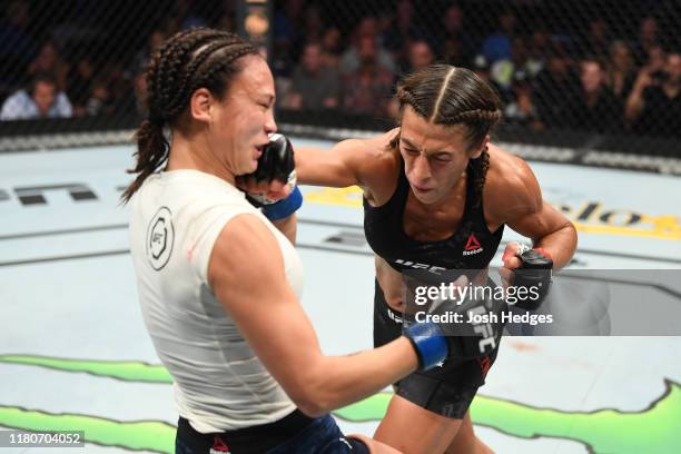 Joanna Jedrzejczyk of Poland punches Michelle Waterson in their women's strawweight bout during the UFC Fight Night event at Amalie Arena on October...