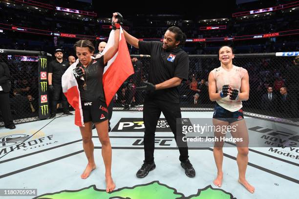Joanna Jedrzejczyk of Poland celebrates her victory over Michelle Waterson in their women's strawweight bout during the UFC Fight Night event at...