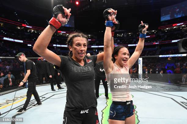 Joanna Jedrzejczyk of Poland and Michelle Waterson react after the conclusion of their women's strawweight bout during the UFC Fight Night event at...