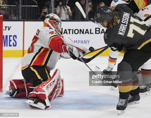 David Rittich of the Calgary Flames makes a save against William Karlsson of the Vegas Golden Knights in the second period of their game at T-Mobile...