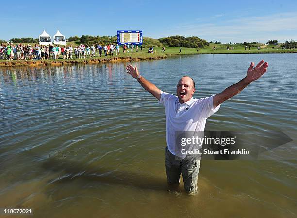 Thomas Levet of France celebrates after jumping into the lake on the 18th hole after winning The Open de France presented by Alstom at the Golf...