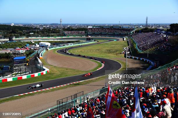 Valtteri Bottas driving the Mercedes AMG Petronas F1 Team Mercedes W10 leads Sebastian Vettel of Germany driving the Scuderia Ferrari SF90 on lap one...