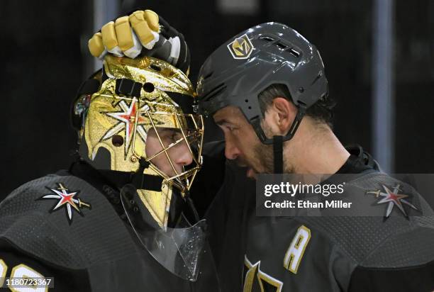 Marc-Andre Fleury and Deryk Engelland of the Vegas Golden Knights celebrate on the ice after the team's 6-2 victory over the Calgary Flames at...