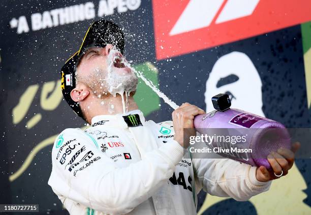 Race winner Valtteri Bottas of Finland and Mercedes GP celebrates on the podium during the F1 Grand Prix of Japan at Suzuka Circuit on October 13,...