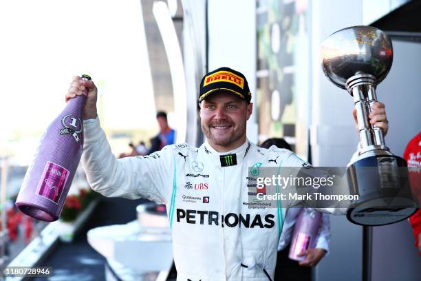 Race winner Valtteri Bottas of Finland and Mercedes GP celebrates on the podium during the F1 Grand Prix of Japan at Suzuka Circuit on October 13,...