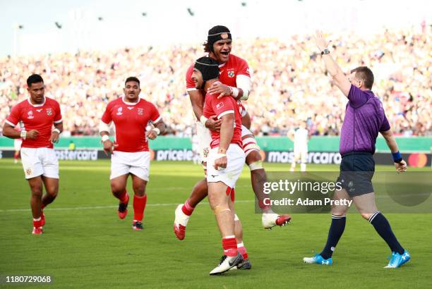 Malietoa Hingano of Tonga celebrates with teammates after scoring his team's second try during the Rugby World Cup 2019 Group C game between USA and...