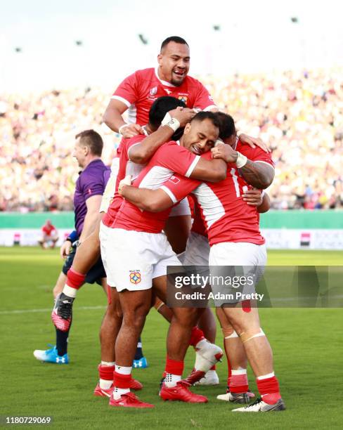Malietoa Hingano of Tonga celebrates with teammates after scoring his team's second try during the Rugby World Cup 2019 Group C game between USA and...