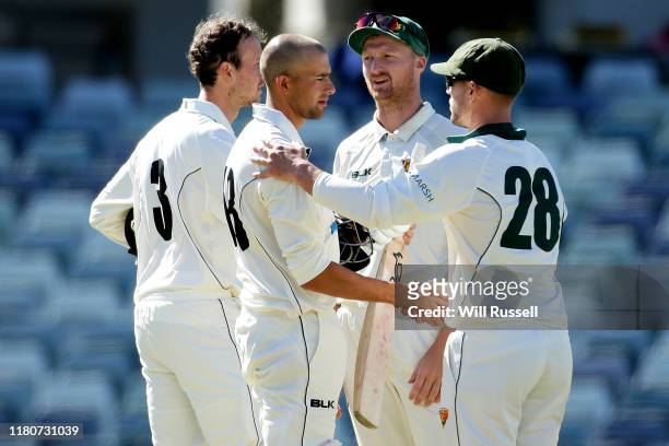 Ashton Agar of the Warriors shakes hands with Ben McDermott of the Tigers after play ends during day four of the Sheffield Shield match between...