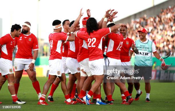Siale Piutau of Tonga is congratulated by teammates after kicking a conversion during the Rugby World Cup 2019 Group C game between USA and Tonga at...