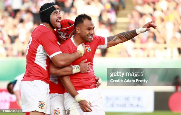 Telusa Veainu of Tonga is congratulated by teammates after scoring his team's fourth try during the Rugby World Cup 2019 Group C game between USA and...