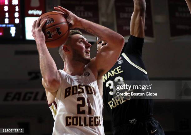 Boston College Eagles forward Nik Popovic goes up for two as he is defended by Wake Forest Demon Deacons forward Ody Oguama during the second half....