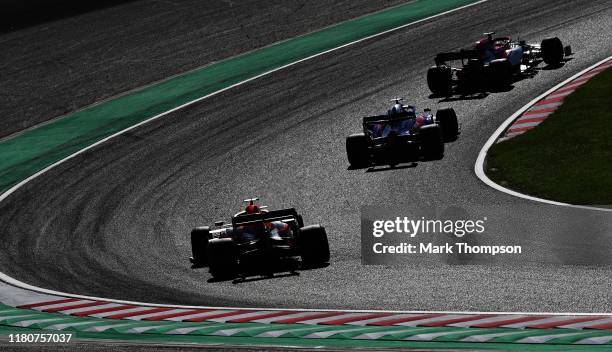 Kimi Raikkonen of Finland driving the Alfa Romeo Racing C38 Ferrari leads Daniil Kvyat driving the Scuderia Toro Rosso STR14 Honda and Max Verstappen...