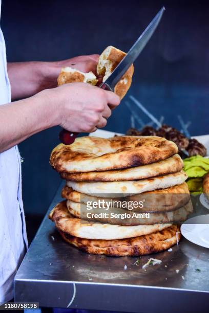 slicing uzbek non bread in a teahouse - naan stock pictures, royalty-free photos & images