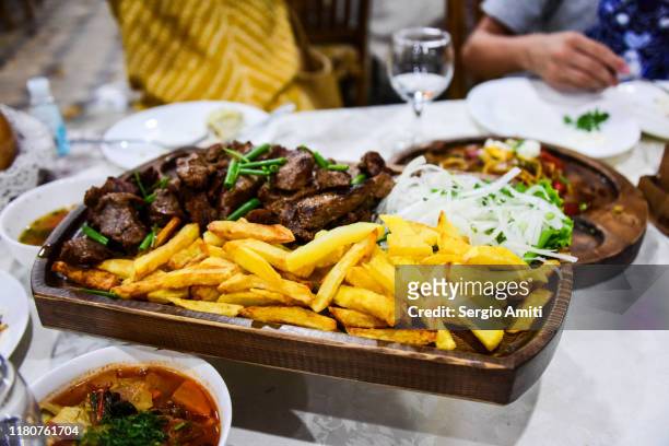 uzbek meal with shahslik, fried laghman, shurpa soup and manti - schaschlik stock-fotos und bilder