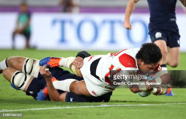 Keita Inagaki of Japan touches down to score their second try as he challenged by Grant Gilchrist of Scotland during the Rugby World Cup 2019 Group A...