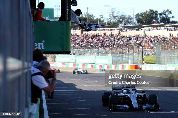 Race winner Valtteri Bottas driving the Mercedes AMG Petronas F1 Team Mercedes W10 takes the chequered flag during the F1 Grand Prix of Japan at...