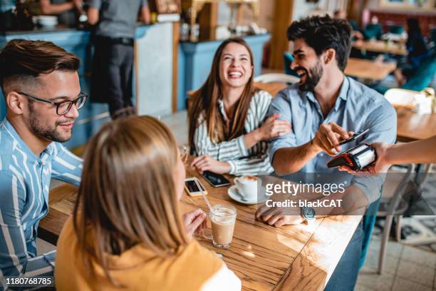 contactless payment in a coffee shop - paying stock pictures, royalty-free photos & images