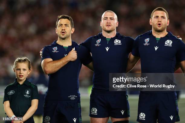 Greig Laidlaw, Stuart Hogg and Finn Russell of Scotland sing the national anthem prior to the Rugby World Cup 2019 Group A game between Japan and...