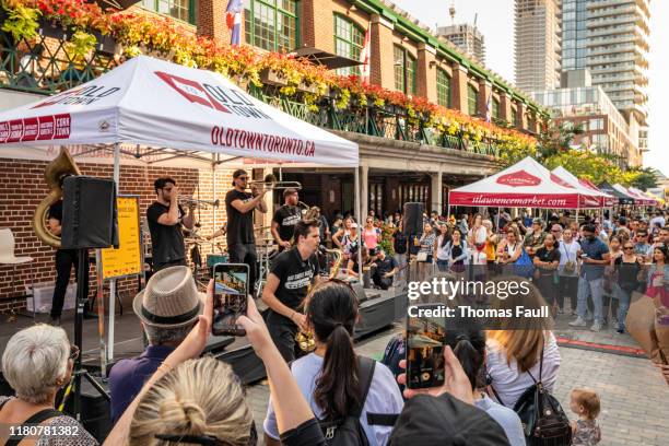 street musicians play on a stage in toronto - street performer stock pictures, royalty-free photos & images