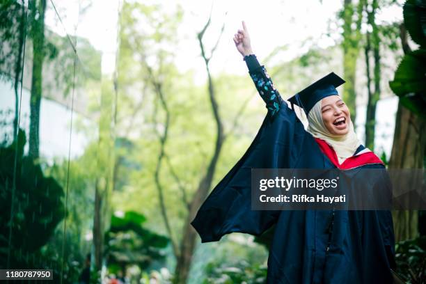 portrait of college student cheering on her graduation day - graduation excitement stock pictures, royalty-free photos & images