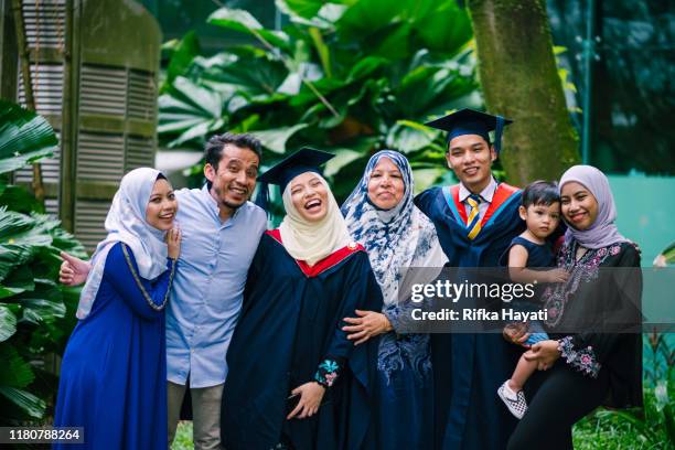 portrait of young beautiful women in graduation gown with family - islam family stock pictures, royalty-free photos & images