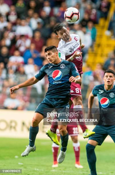 Motaguas Hector Castellanos vies for the ball with Saprissa's Michael Barrantes during the Concacaf Champions League final football match between...