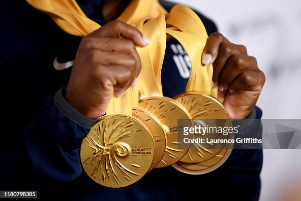 Detailed view as Simone Biles of The United States poses for photos with her multiple gold medals during day 10 of the 49th FIG Artistic Gymnastics...