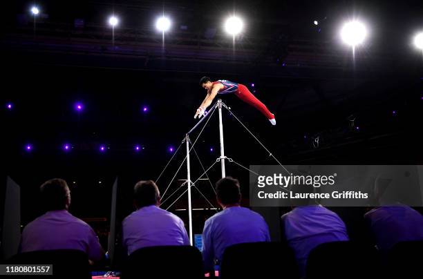 Judges watch Chia-Hung Tang of Taipei competing in Men's Horizontal Bar Final during day 10 of the 49th FIG Artistic Gymnastics World Championships...