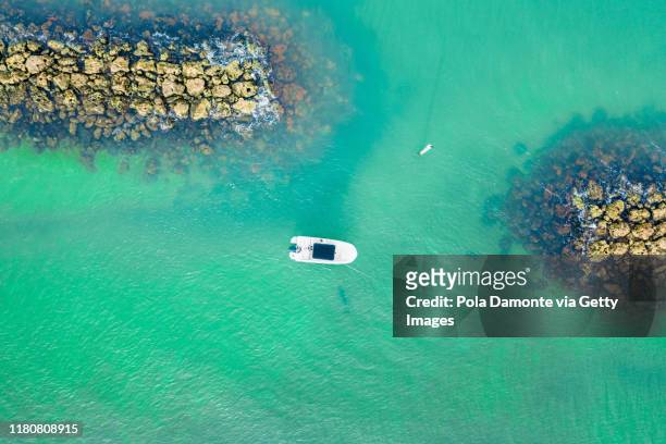 aerial drone view of a ship in the sea in marco island, florida at sunrise - boat top view stock pictures, royalty-free photos & images
