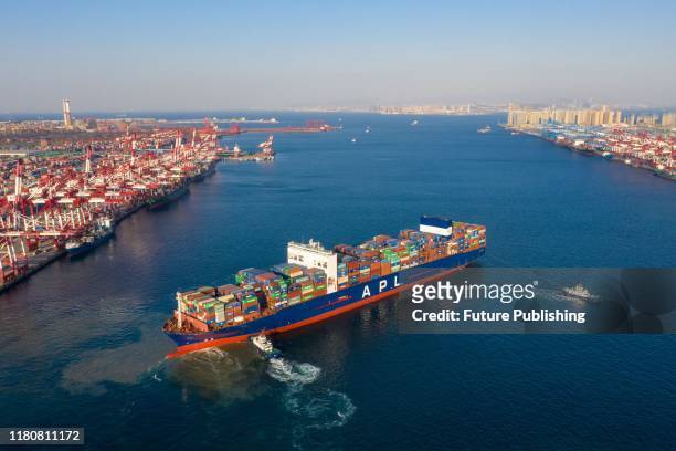Tugboats move an APL container ship to the dockyard in Qingdao in east China's Shandong province Monday, Nov. 04, 2019.- PHOTOGRAPH BY Feature China...