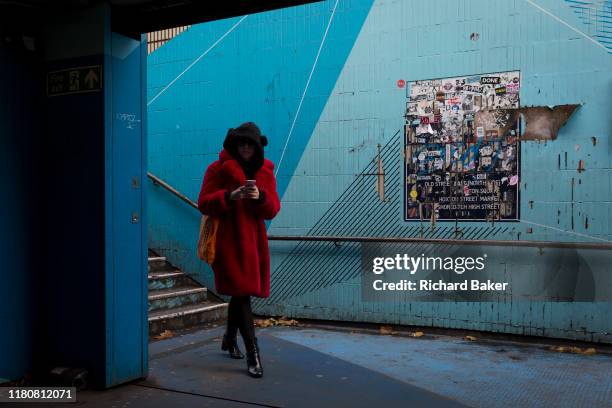 Lone woman enters the underpass leading into the Old Street station in Shoreditch, on 4th November 2019, in London, England.