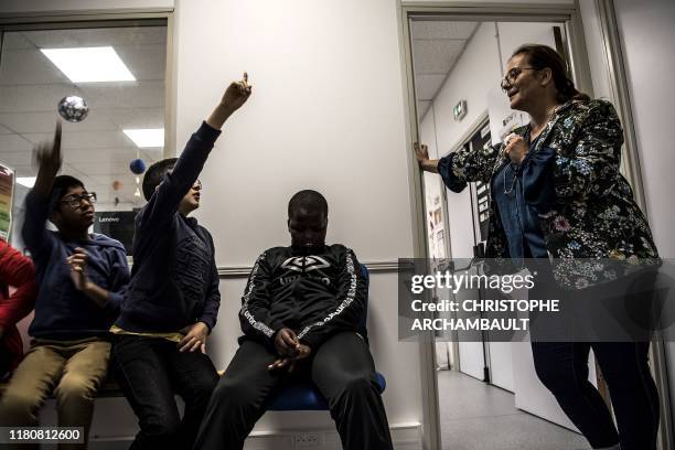 Autistic children attend a course delivered by a specialised teacher Caroline Berge at the College du Parc in Aulnay-sous-Bois, northeast of Paris on...