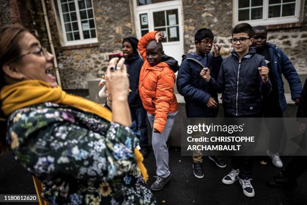 Autistic children pose for a picture taken by a specialised teacher Caroline Berge at the College du Parc in Aulnay-sous-Bois, northeast of Paris on...