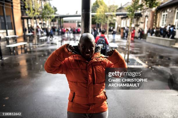 An autistic child Alioune is pictured during a break in a course delivered by a specialised teacher Caroline Berge at the College du Parc in...