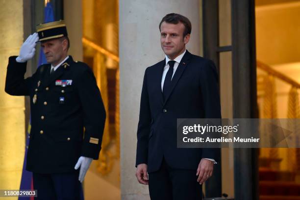 French President Emmanuel Macron welcomes German Chancelor Angela Merkel for a meeting at Elysee Palace on October 13, 2019 in Paris, France....