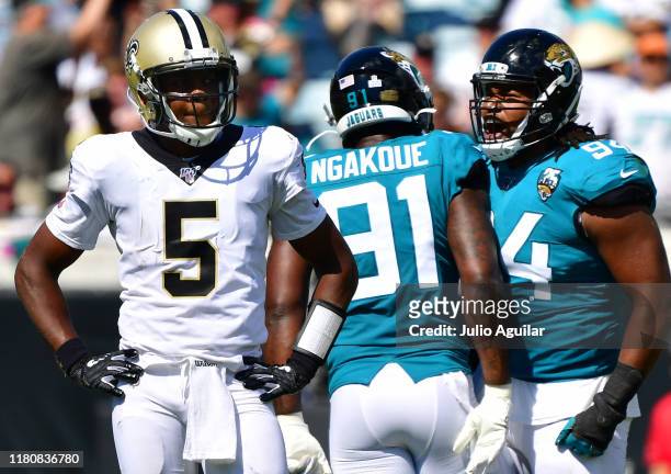 Defensive end Josh Allen of the Jacksonville Jaguars reacts with teammate defensive end Yannick Ngakoue after sacking quarterback Teddy Bridgewater...
