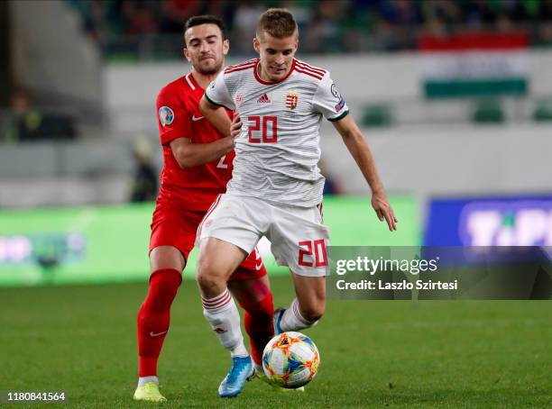 Gara Garayev of Azerbaijan challenges Istvan Kovacs of Hungary during the 2020 UEFA European Championships group E qualifying match between Hungary...