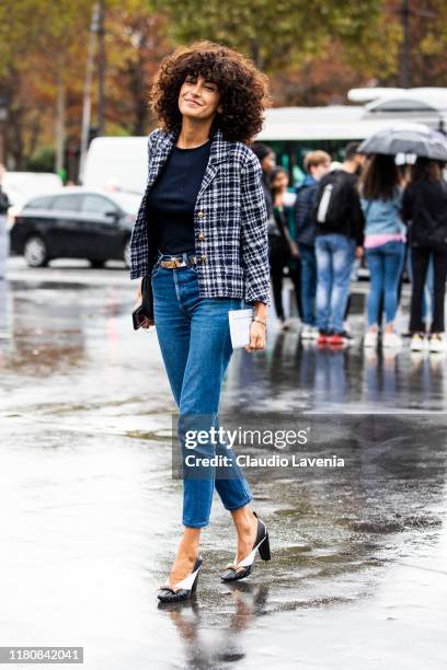 Brune Buonomano, wearing a blue checked blazer, blue jeans and black and white heels, is seen outside the Chanel show during Paris Fashion Week -...