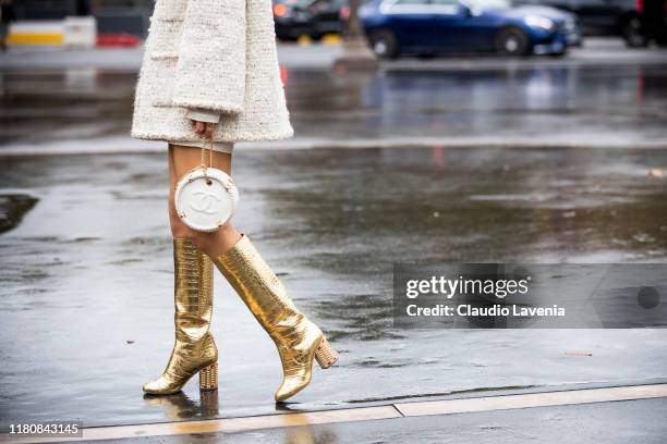 Ki Eunse, wearing a cream decorated jacket, Chanel bag and gold boots, is seen outside the Chanel show during Paris Fashion Week - Womenswear Spring...