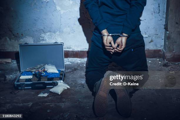 arrested man in handcuffs - drug trafficking stock pictures, royalty-free photos & images