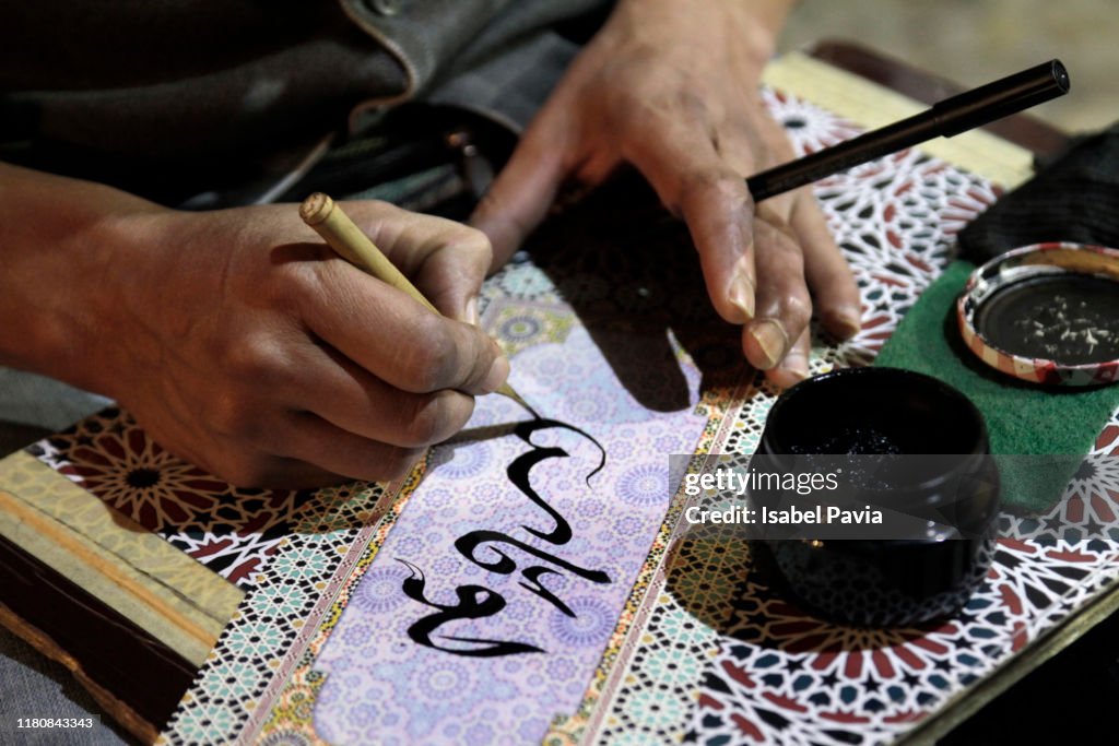 Close-up of Man Writing Arabic Calligraphy