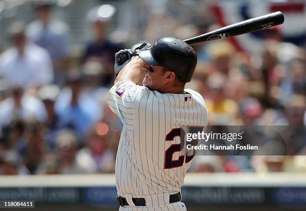 Jim Thome of the Minnesota Twins hits a solo home run against the Milwaukee Brewers in the second inning on July 3, 2011 at Target Field in...