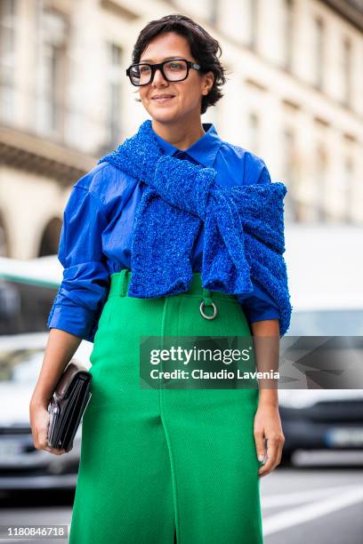 Ksenia Chilingarova, wearing a blue shirt, blue sweater and green midi skirt, is seen outside the Giambattista Valli show during Paris Fashion Week -...